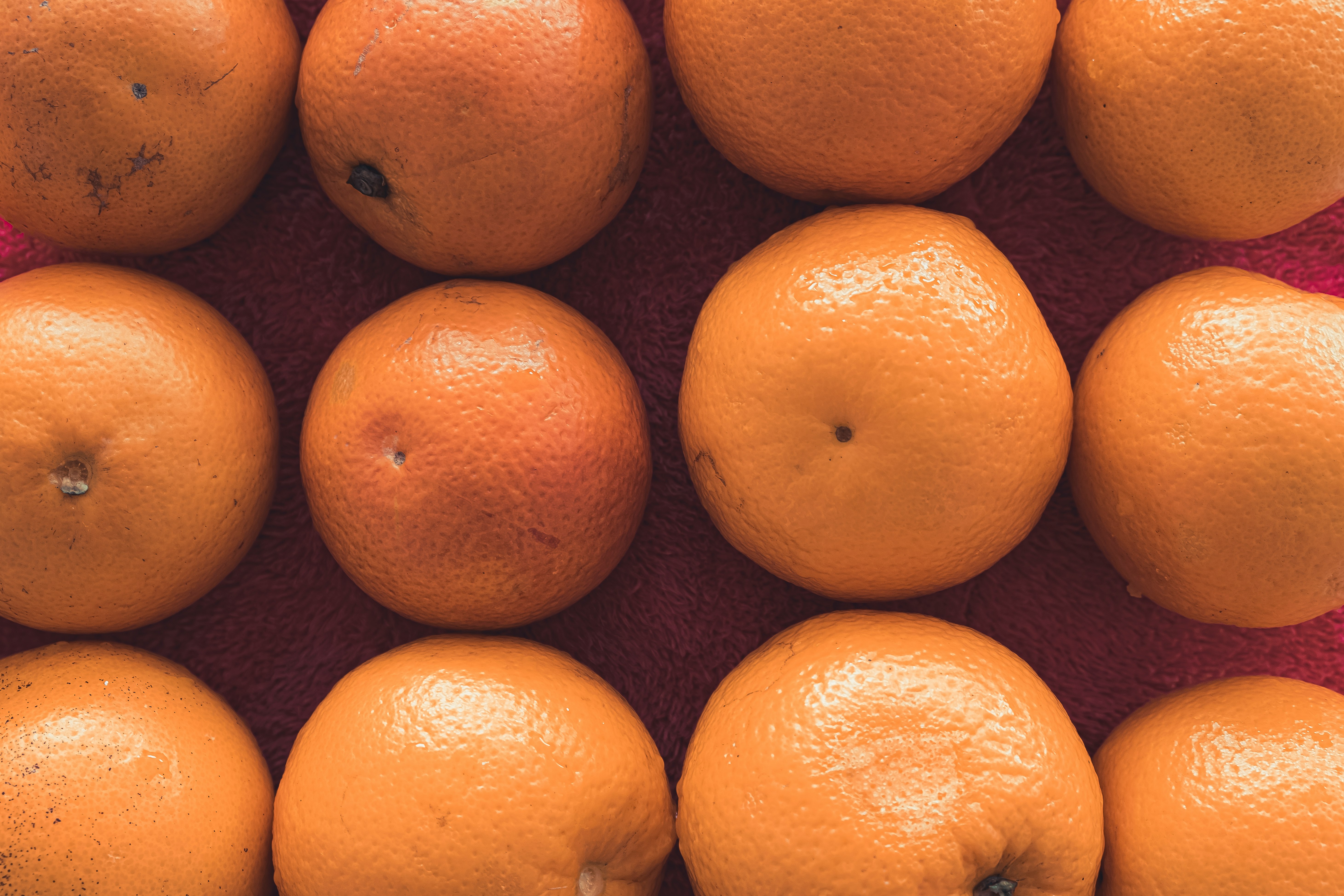 orange fruits on brown surface